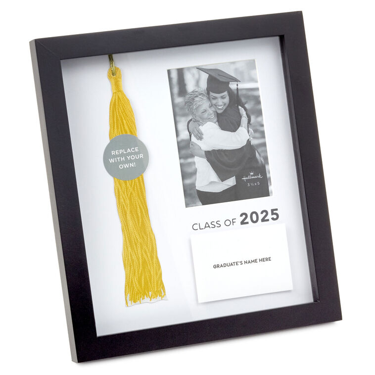 A black frame with a photo and a yellow graduation tassel in it