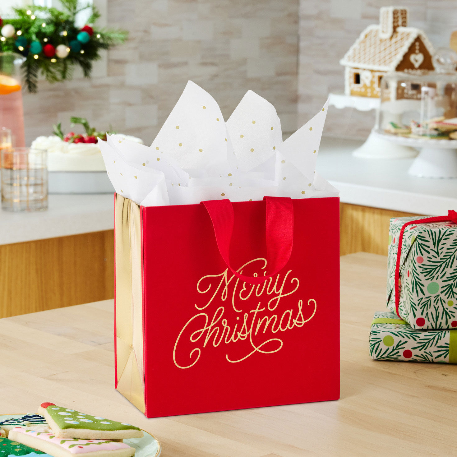 Gold Lettering on Red Christmas Gift Bag with Tissue in use image number 2