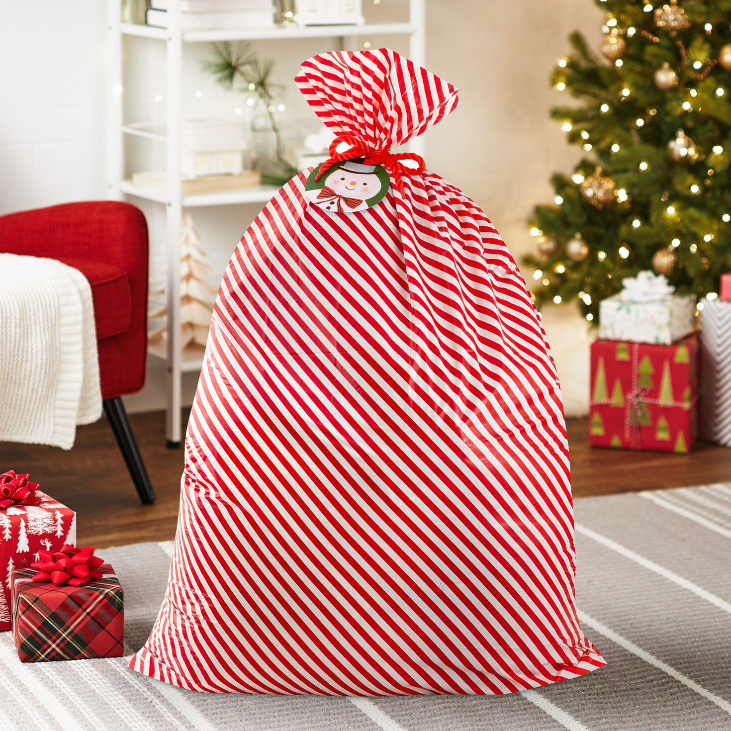 Snowman Plastic Christmas Gift Bag With Tag and Tie in use image number 2