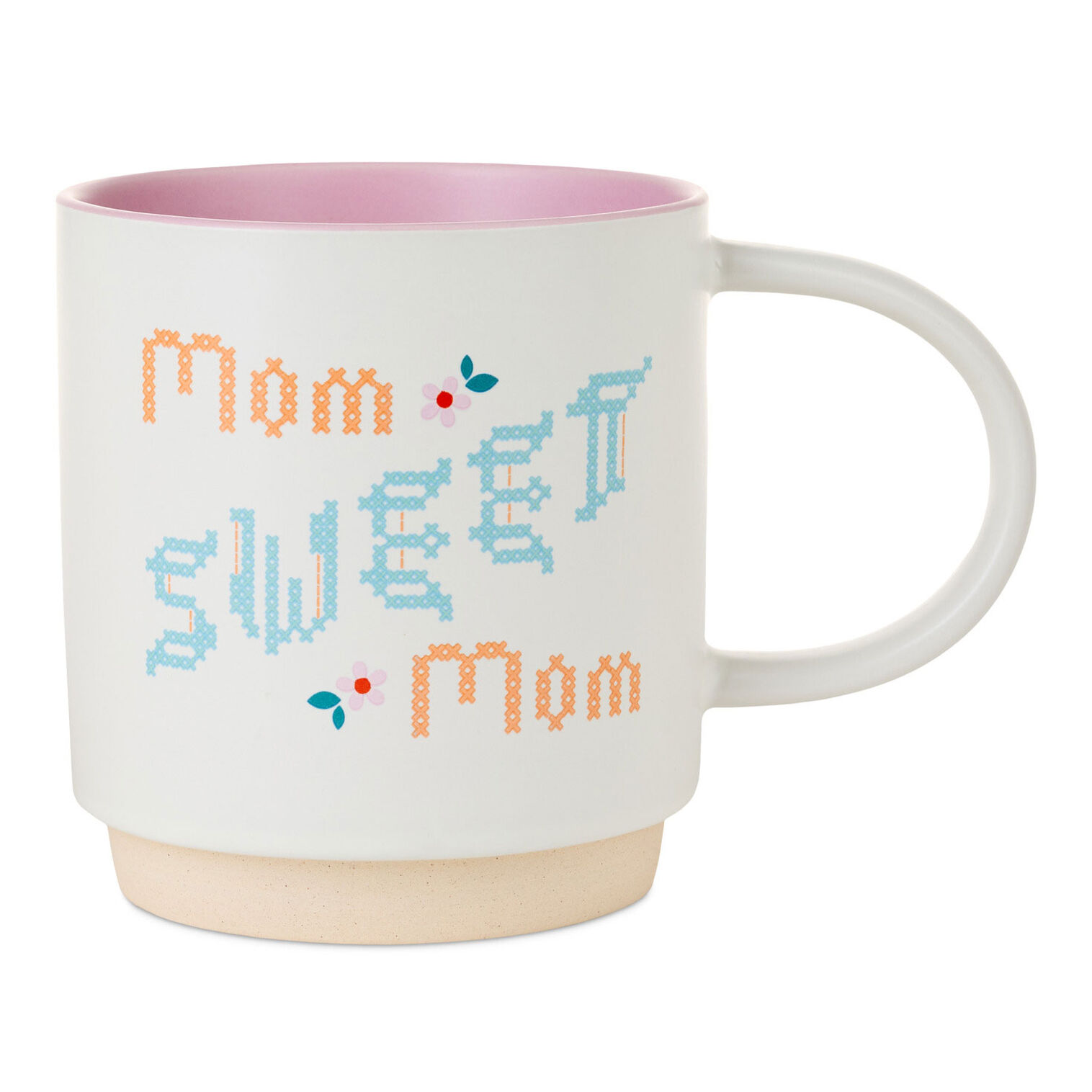 A white mug with cross stitch text on it