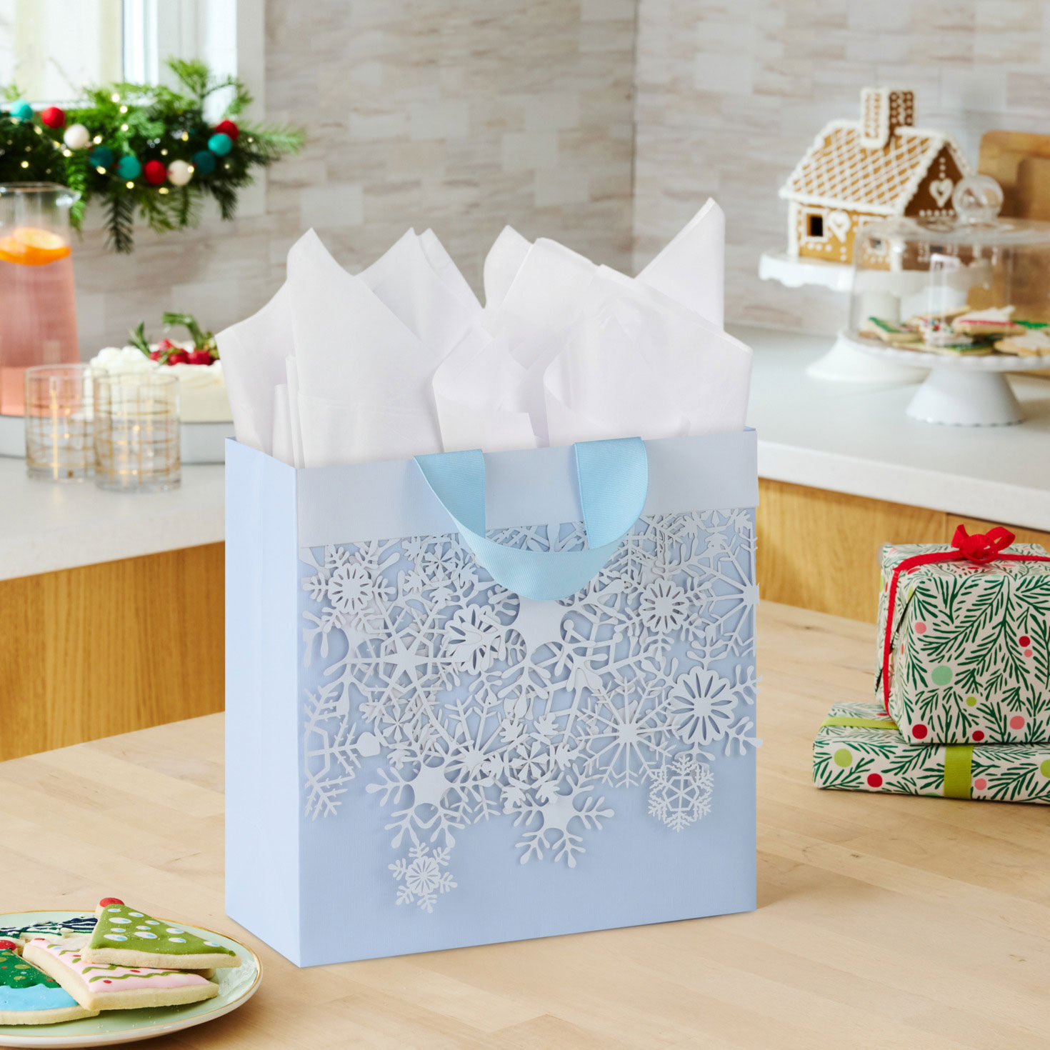 White Snowflakes Square Holiday Gift Bag with Tissue in use image number 2