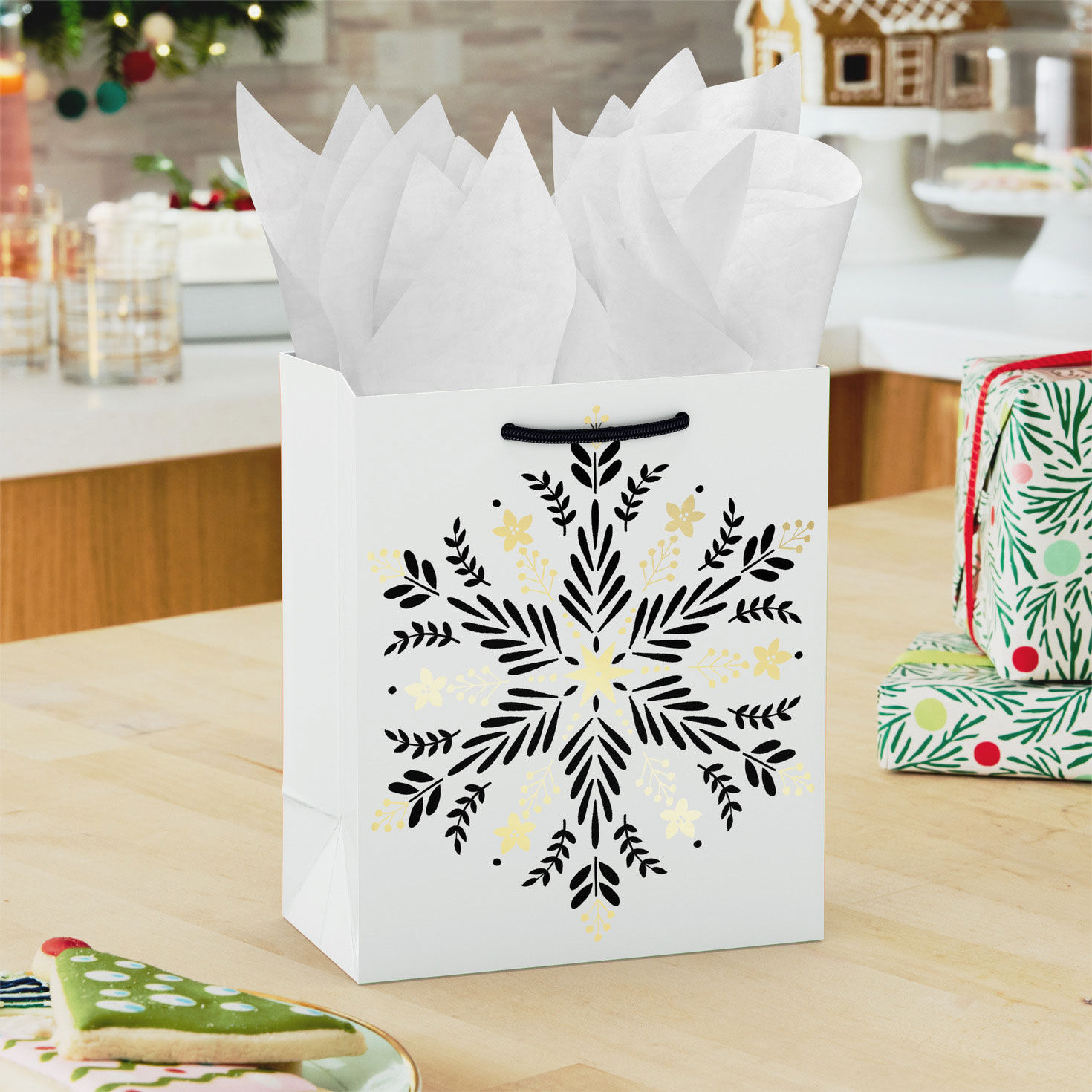 Black and Gold Snowflake Small Holiday Gift Bag in use image number 2