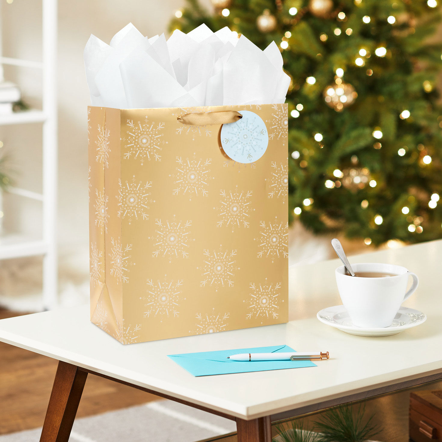 Snowflakes on Gold Metallic Large Holiday Gift Bag In Use image number 2