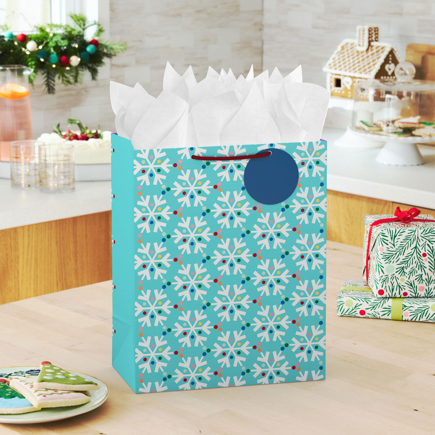 Snowflakes on Blue Large Holiday Gift Bag with Tissue in use image number 2