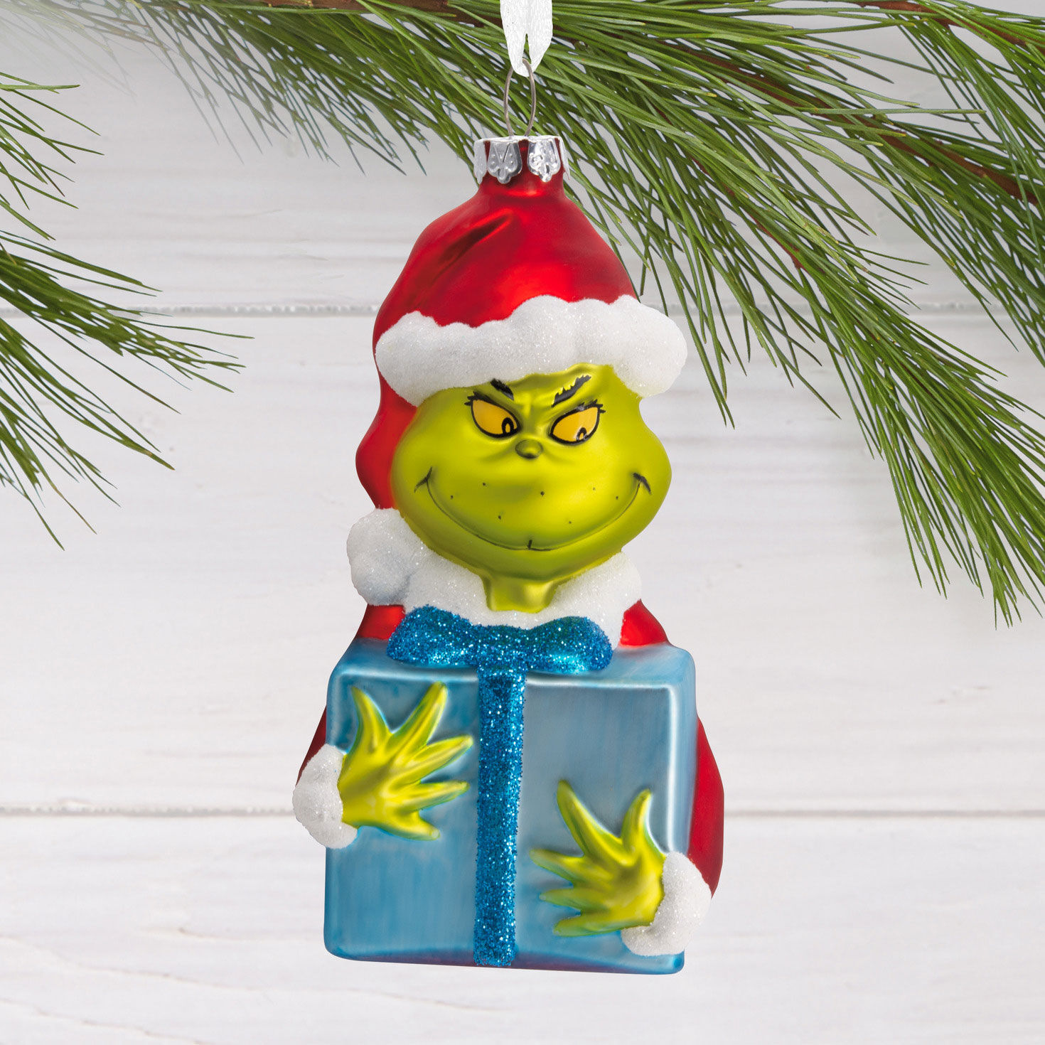 Grinch With Present Glass Christmas Ornament hanging on tree image number 2