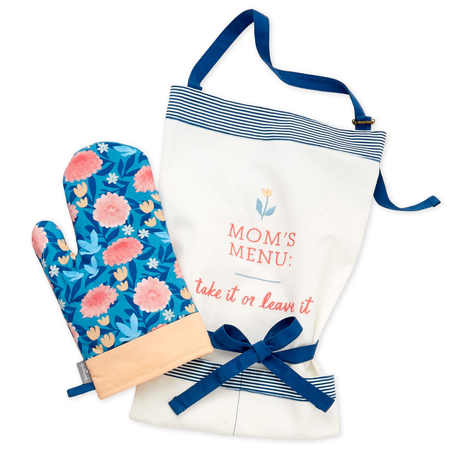 A blue floral oven mitt next to a white and blue apron with red text on it