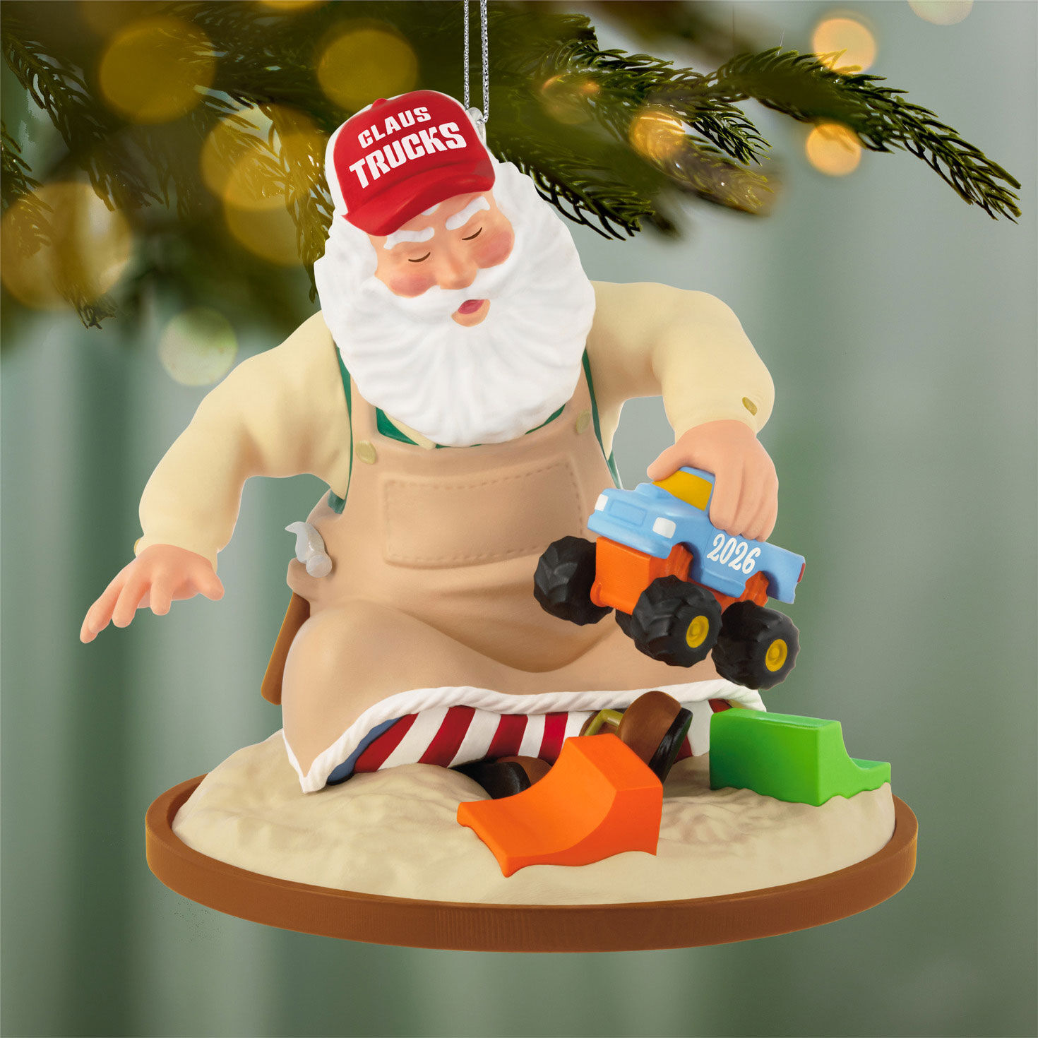 Santa Playing Trucks in Sand Box Keepsake Ornament hanging on tree image number 2