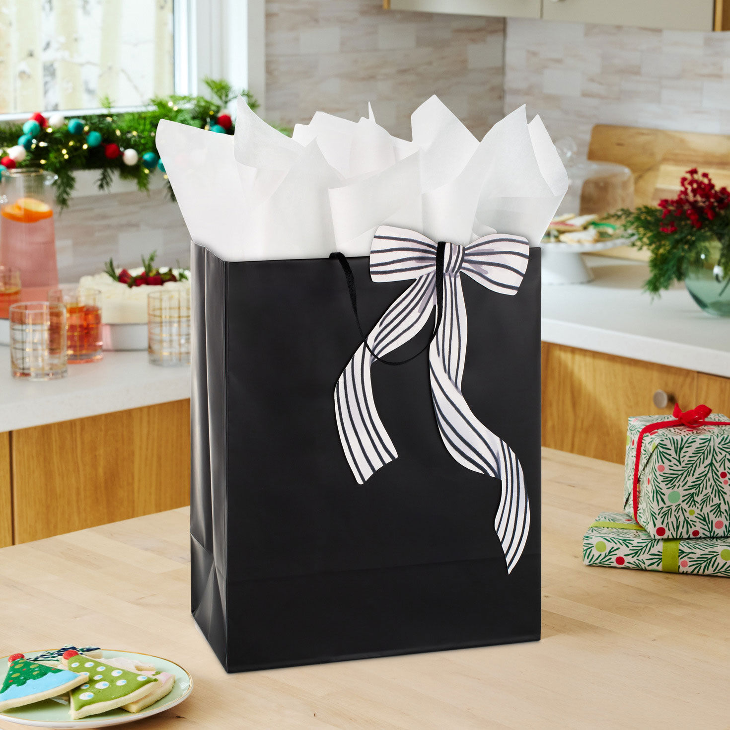 Solid Black Large Holiday Gift Bag with Bow in use image number 2