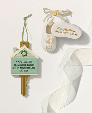 Home key and baby shoes ornaments on a white background.