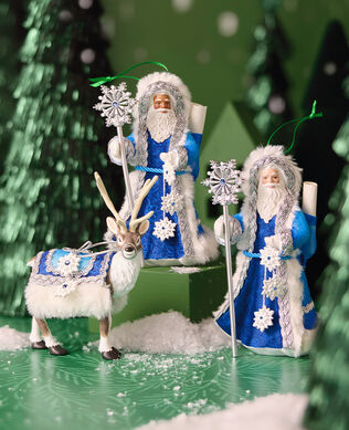 Father Christmas ornaments on green background with snow