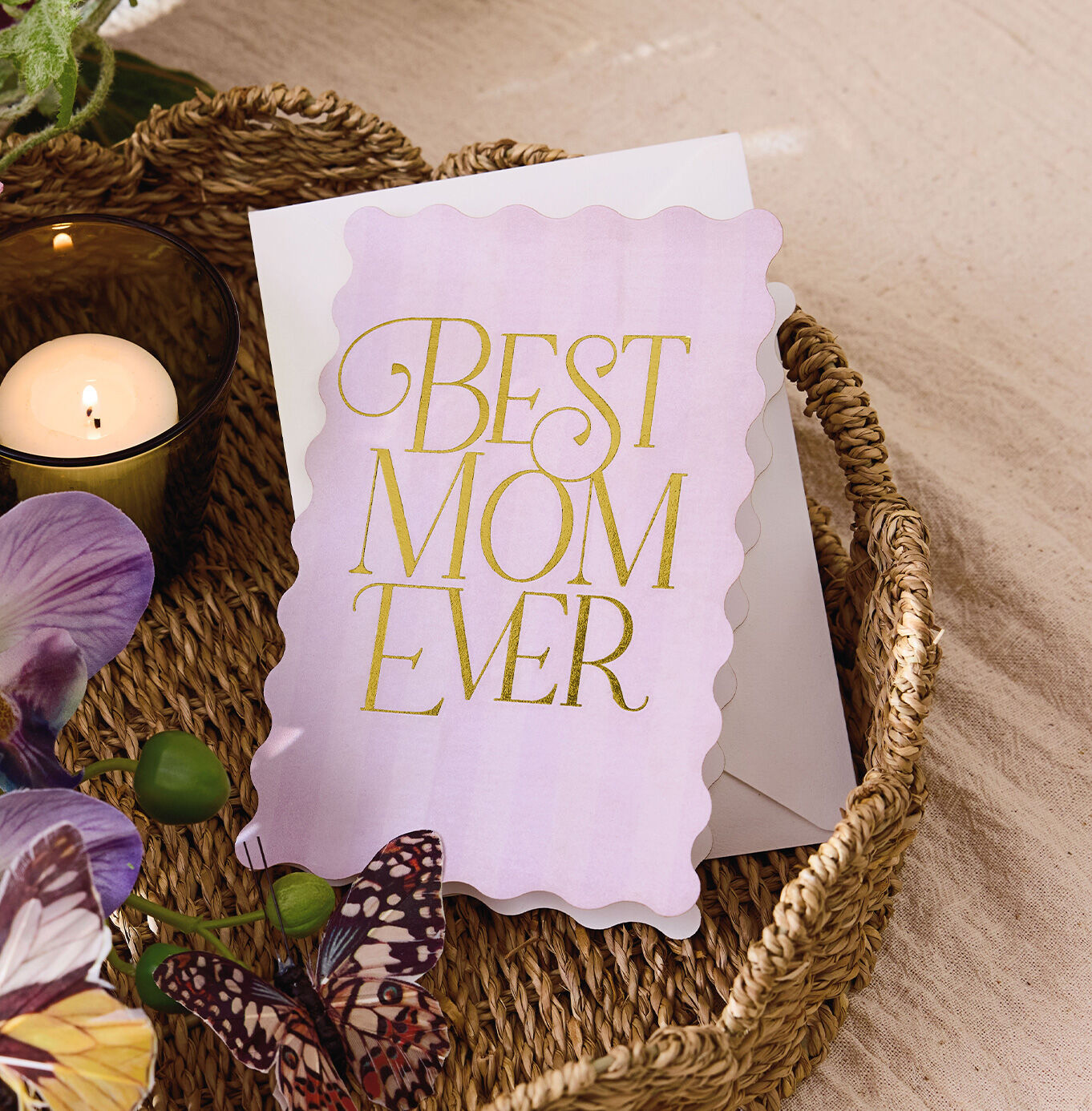 Lilac card with Best mom ever' in gold sitting in a table basket.