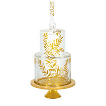 Clear-glass wedding cake ornament with metallic gold leaf designs and 2025 ribbon.