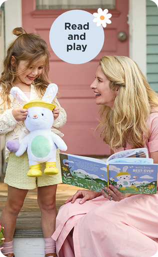 Mother and daughter holding a matching stuffed rabbit and book