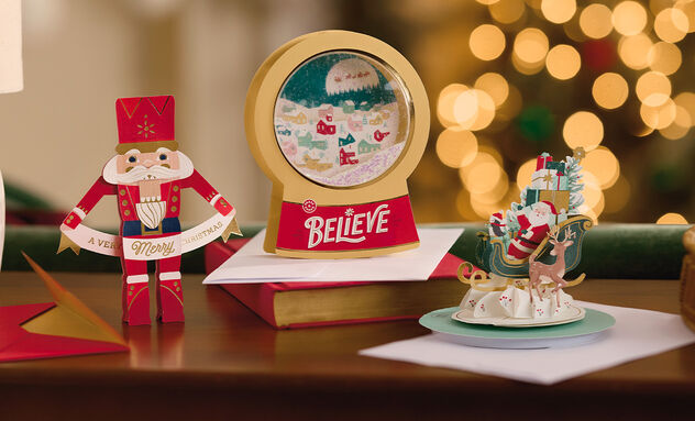 Three 3D Christms cards standing on a table.
