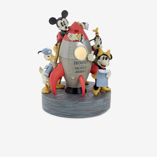 Mickey Mouse and friends standing around a retro rocket.