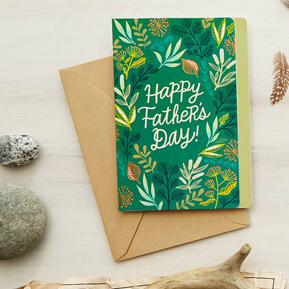 A green card with floral patterns that says Happy Fathers Day