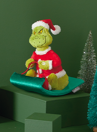 The Grinch on a sled stuffed animal