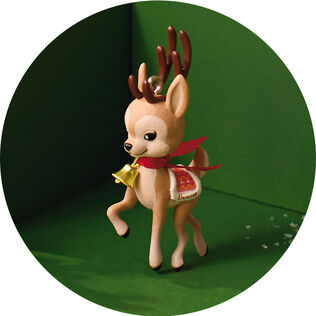 Deer with a Christmas cape and bell. 