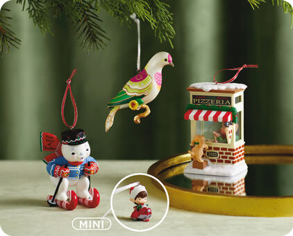 Four KOC exclusive ornaments on a table and mirrored tray.