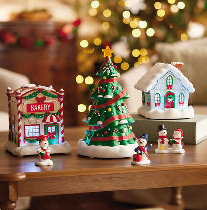 A Christmas themed village set of sculptures and figurines.