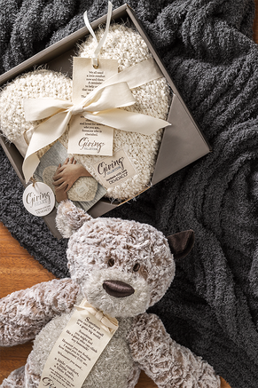 Giving heart cream pillow and bear stuffed animal.