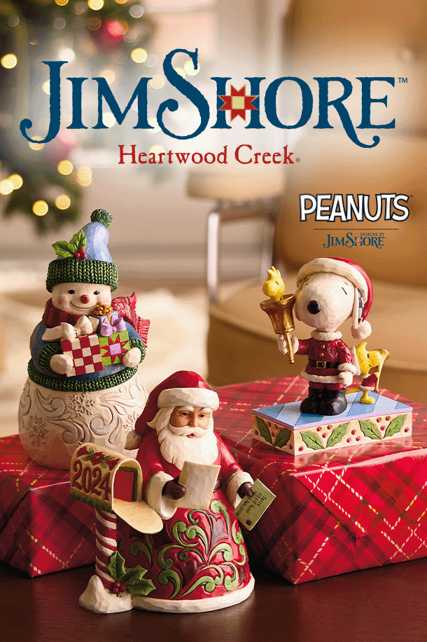 Jim Shore Santa, snowman, and Snoopy and Woodstock figures on a table with wrapped gifts.