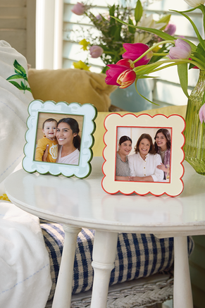 Mint and cream colored enamel frames with family photos.