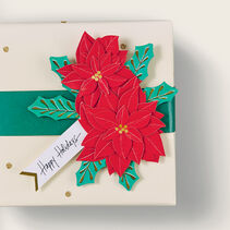 Poinsettia gift tag on a gift. 