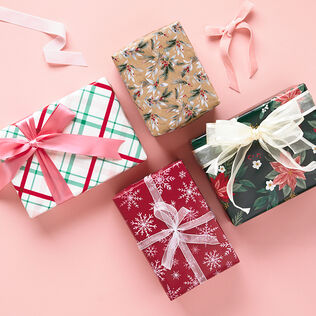 holiday wrapping paper on a pink background