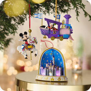 Three Disney ornaments hanging or on a table