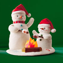 Plush snowmen roasting marshmallows and signing with lights and sound.