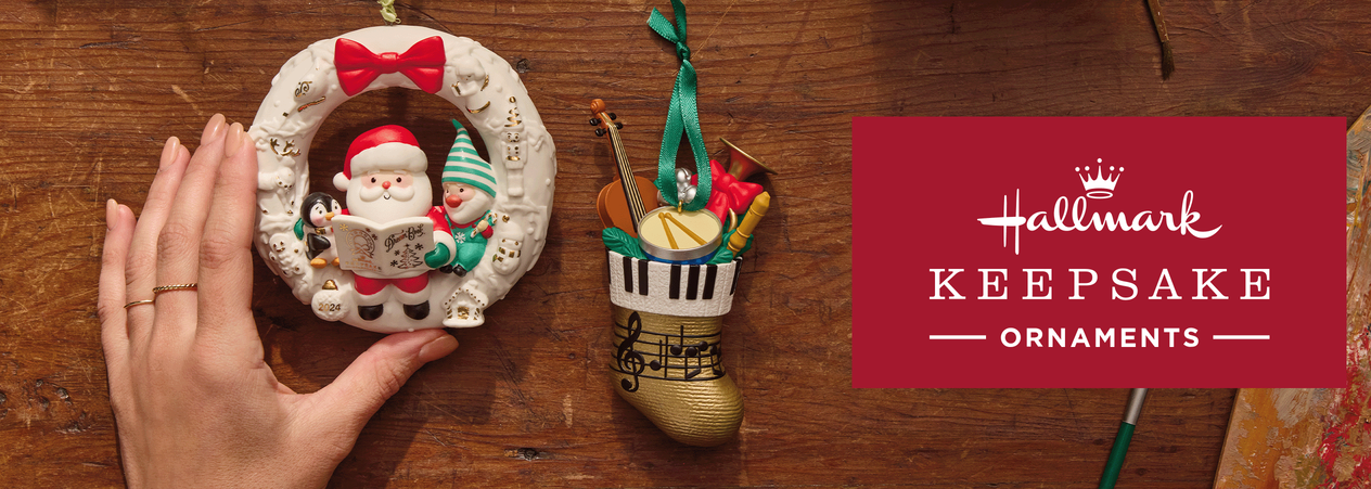 A display of Keepsake Ornaments, including a Santa wreath and a stocking full of musical instruments.