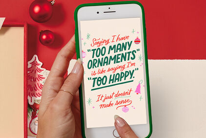 Hand holding a phone with a social post about ornaments open.