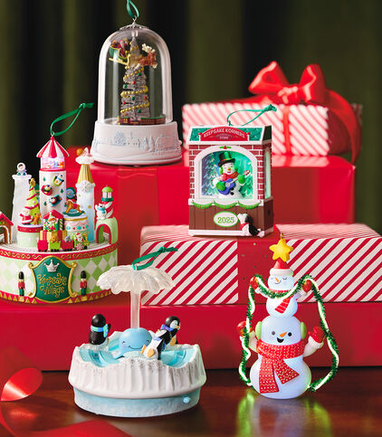 Hallmark ornaments on a table with gift boxes