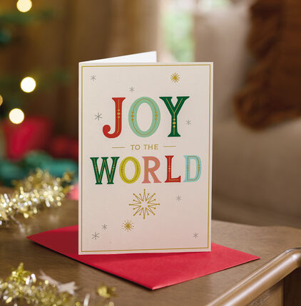Joy to the world card stood on a table.