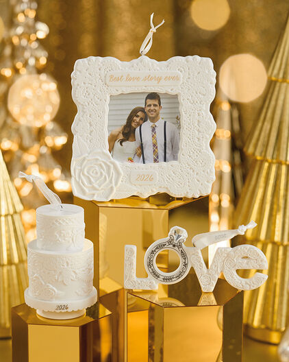 Ornaments celebrating life milestones on gold pedestals.