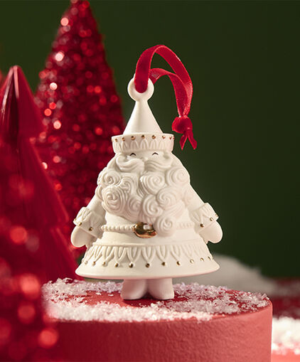 Porcelain Santa Claus ornament with red accent gems on a red stand. 