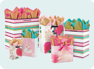 Different gift wrap with a floral and striped theme.