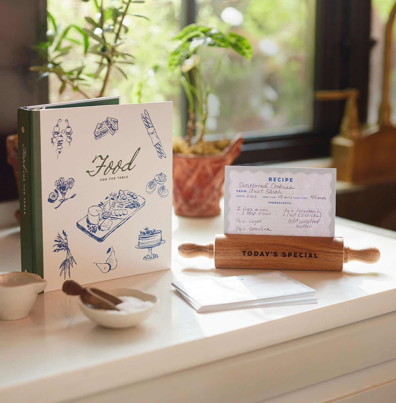 Recipe keeper, recipe cards, and recipe card holder on a kitchen counter.