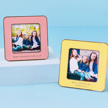 Yellow and pink enamel frames with gold phrases on the bottom section