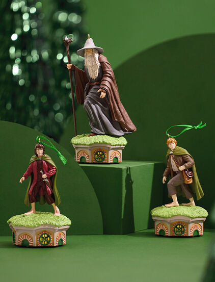 Frodo, Sam and Gandalf the Gray ornaments on green stands. 