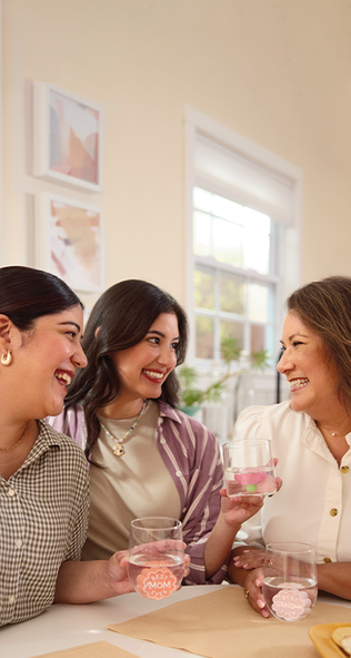 Three generations of women sharing drinks