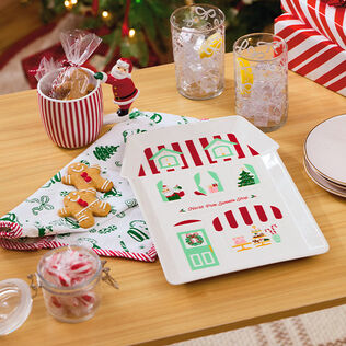 Holiday platter and Santa handled mug on a buffet table.