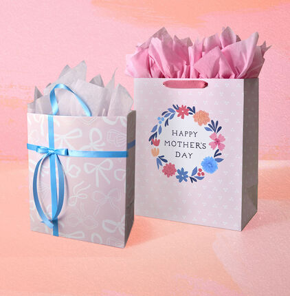 Happy Mothers Day gift bag and white ribbons gift bag filled with tissue paper