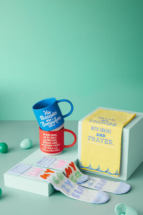 Socks, mugs and a tea towel on a green background 