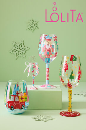 Lolita wine glasses painted with Christmas trees, nutcrackers, red pickup filled with gifts, and poinsettas.