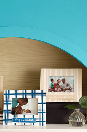 Picture frames with photos of grandparents and grandchildren, and a father and newborn