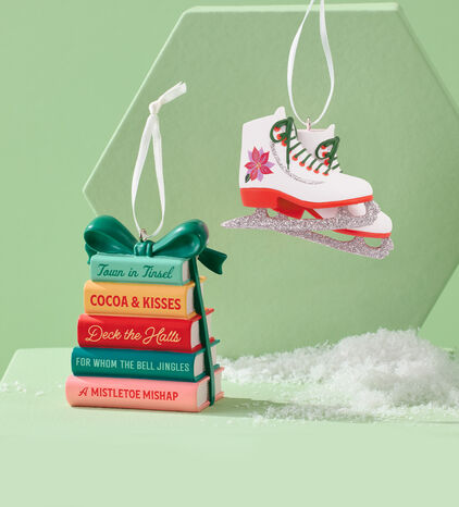 Stack of books ornament and white ice skates ornament. 