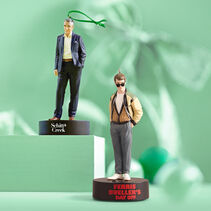Johnny Rose and Ferris Bueller ornaments on green background