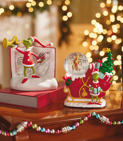 Two Grinch-themed gifts on a table.